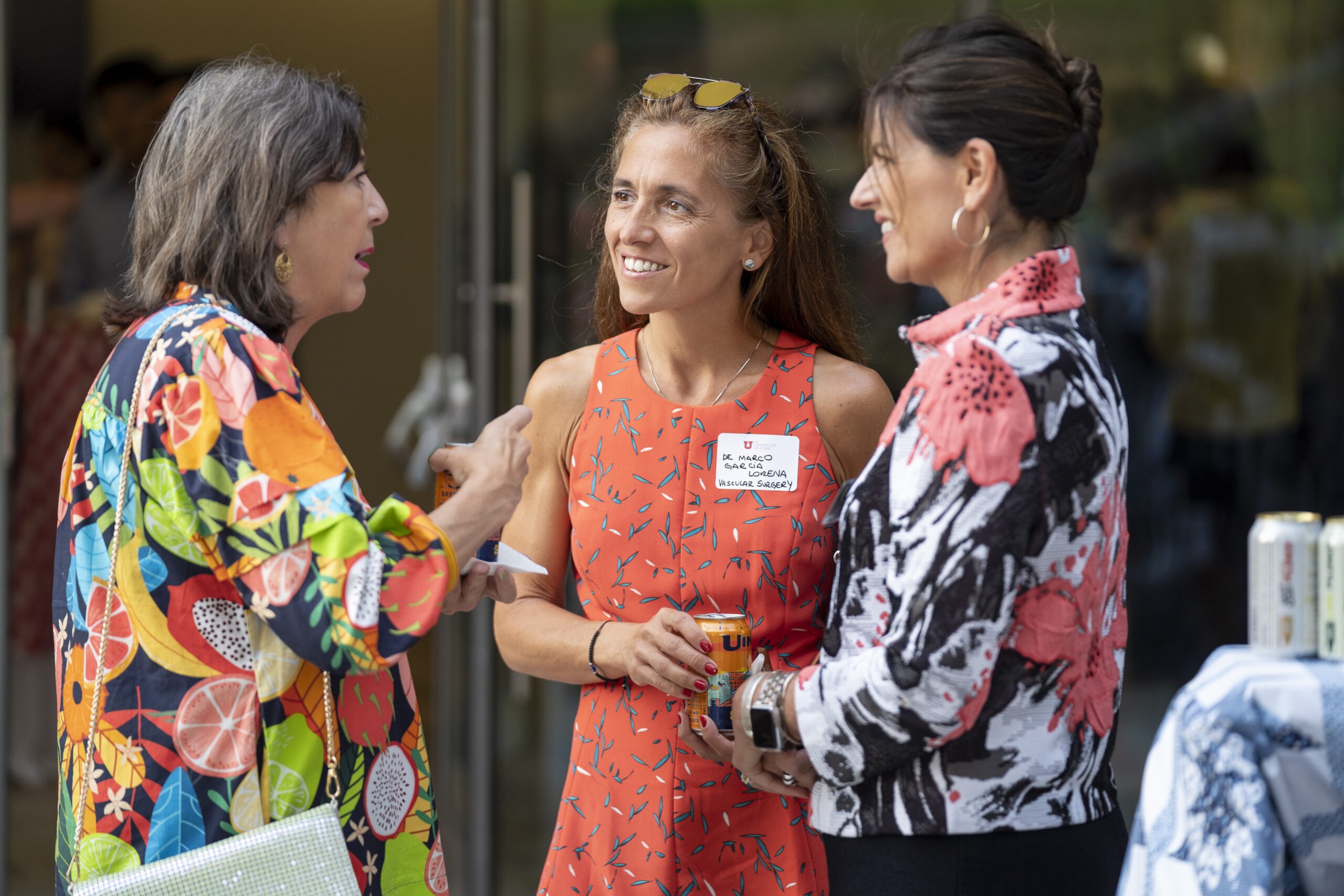 New faculty chatting with Dean Michelle Camacho at Faculty Soiree