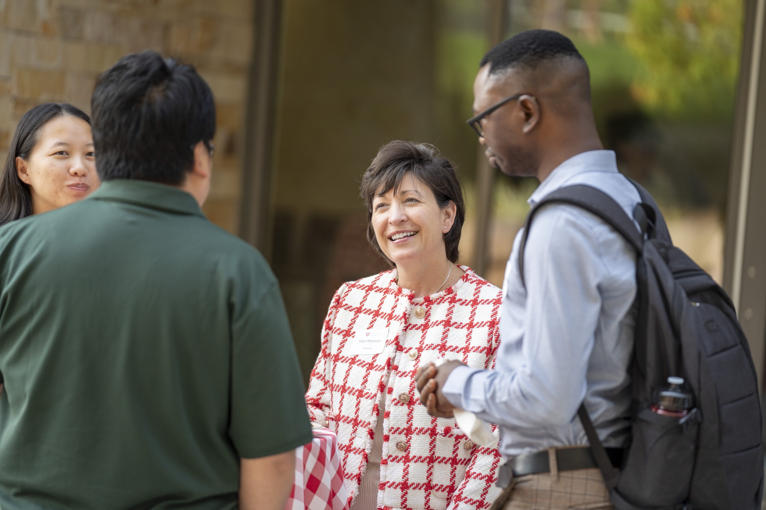 New faculty chatting with Provost Montoya at Faculty Soiree