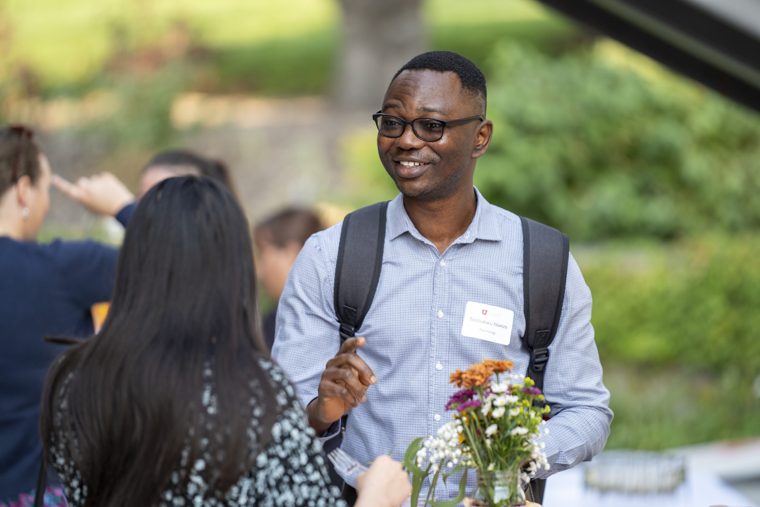 New faculty chatting at Faculty Soiree