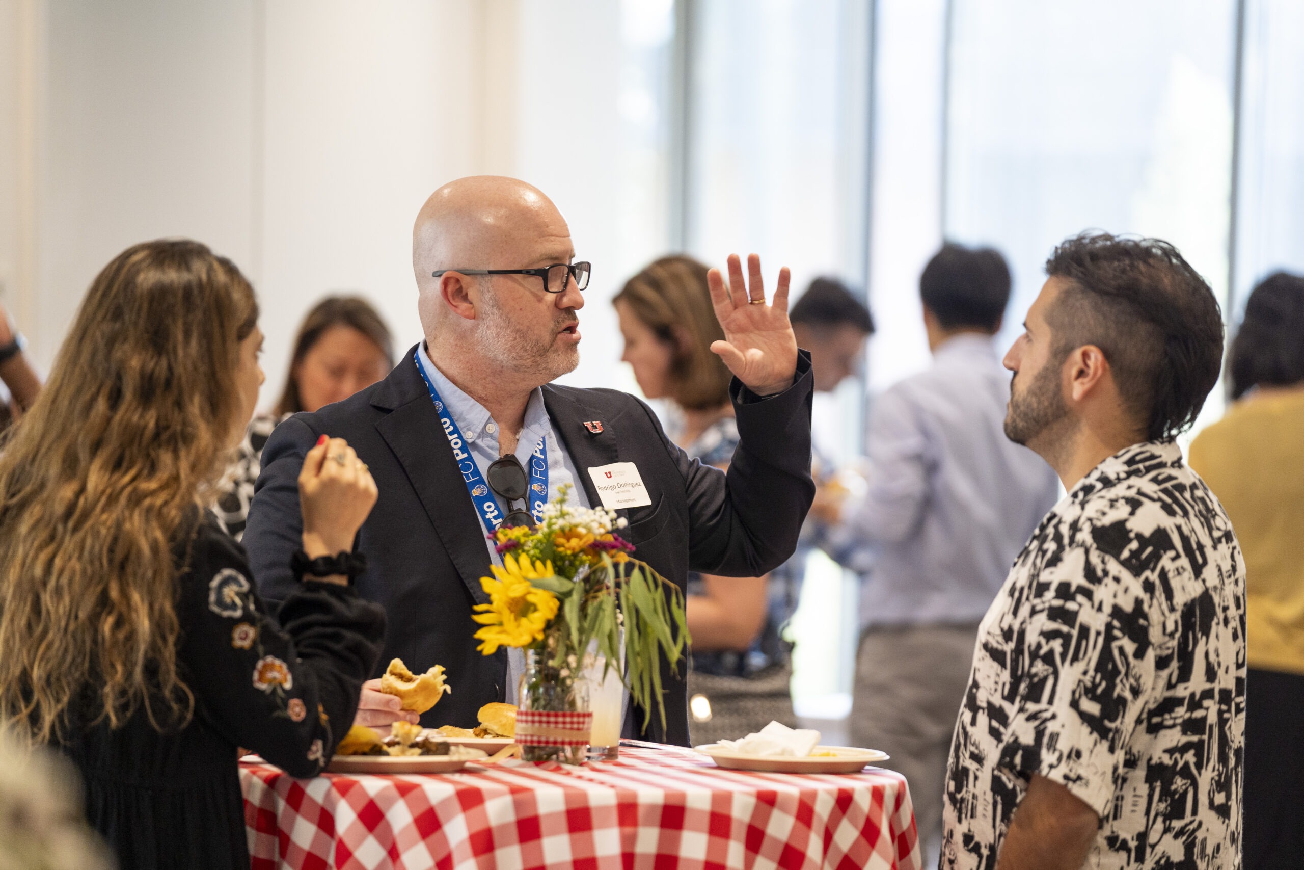 New faculty chatting at Faculty Soiree