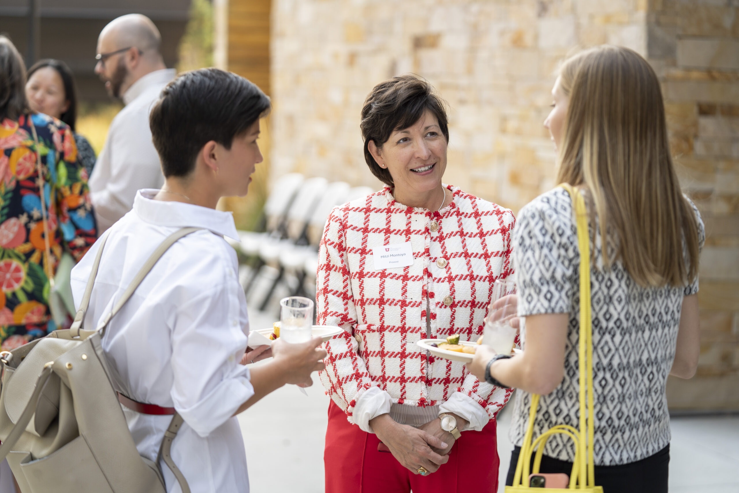 New faculty chatting with Provost Montoya at Faculty Soiree