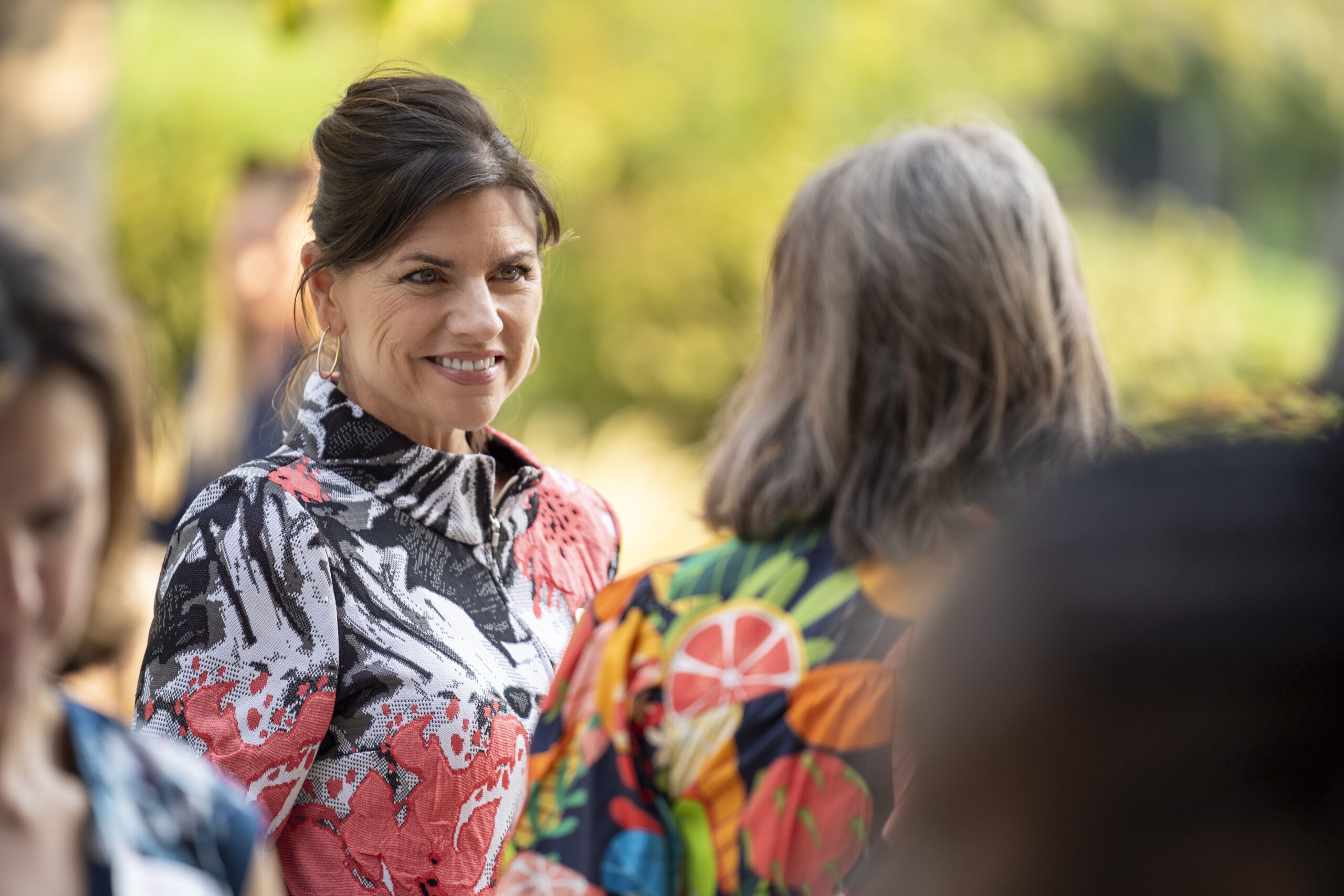 New faculty chatting with Dean Michelle Camacho at Faculty Soiree