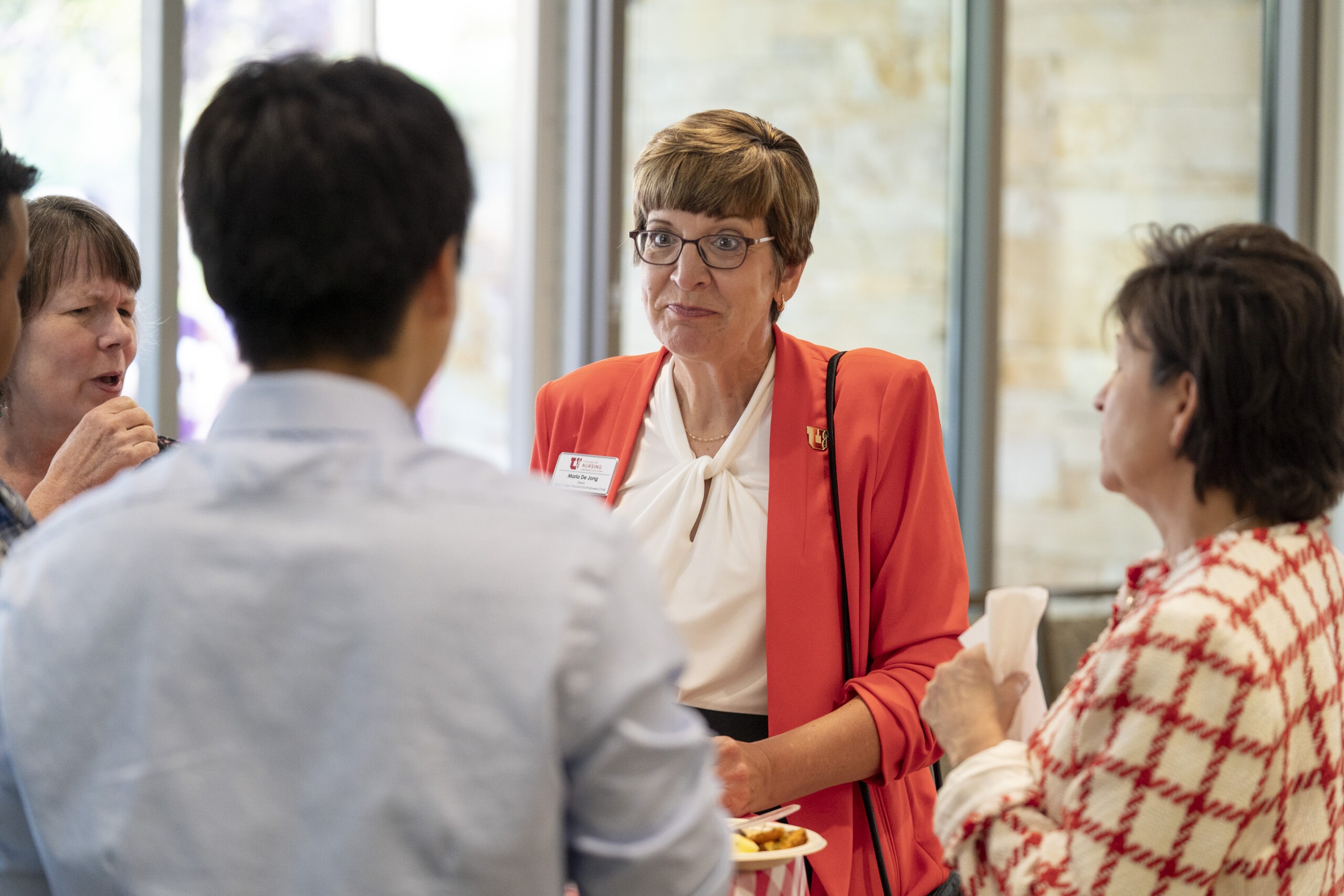 New faculty chatting with Dean Marla De Jong and Provost Mitzi Montoya at Faculty Soiree