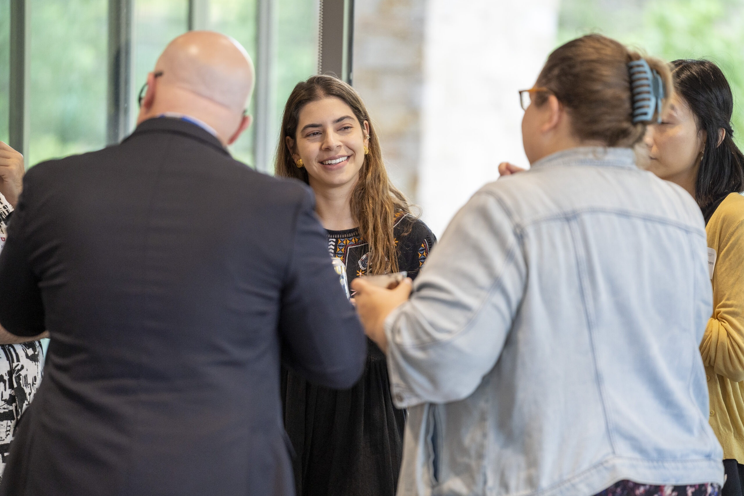 New faculty chatting at Faculty Soiree