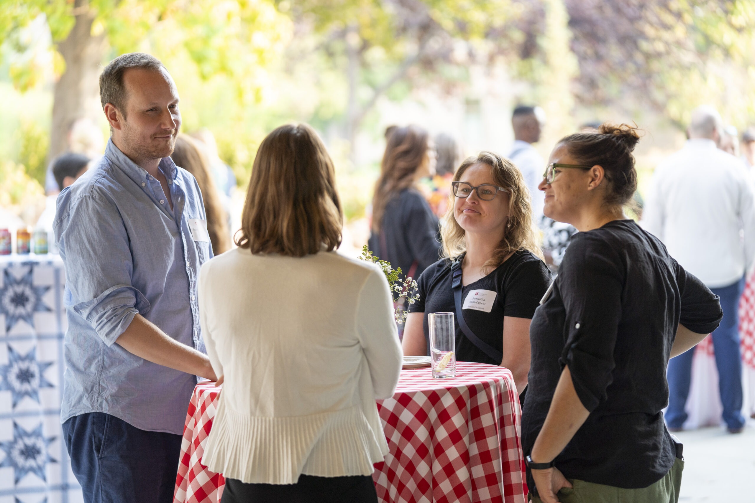 New faculty chatting at Faculty Soiree